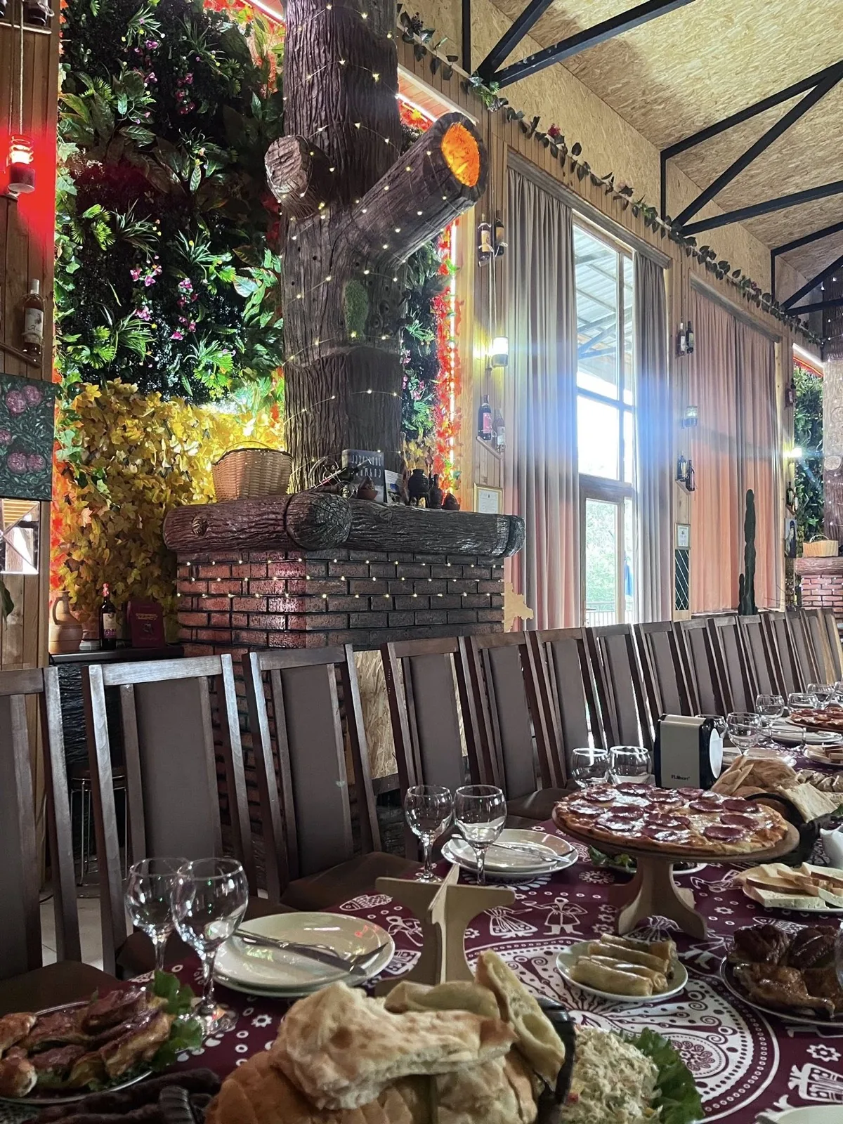 CHAKURA dining room with the long communal table set for a Georgian supra