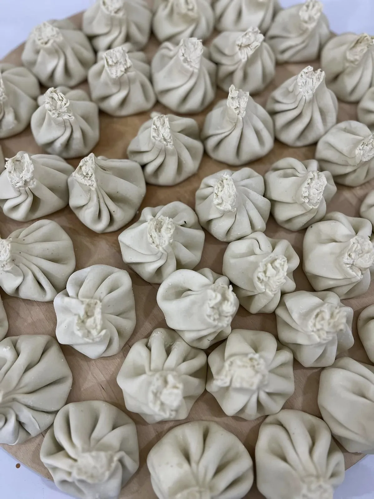 A platter of fresh hand-folded Georgian khinkali dumplings at CHAKURA